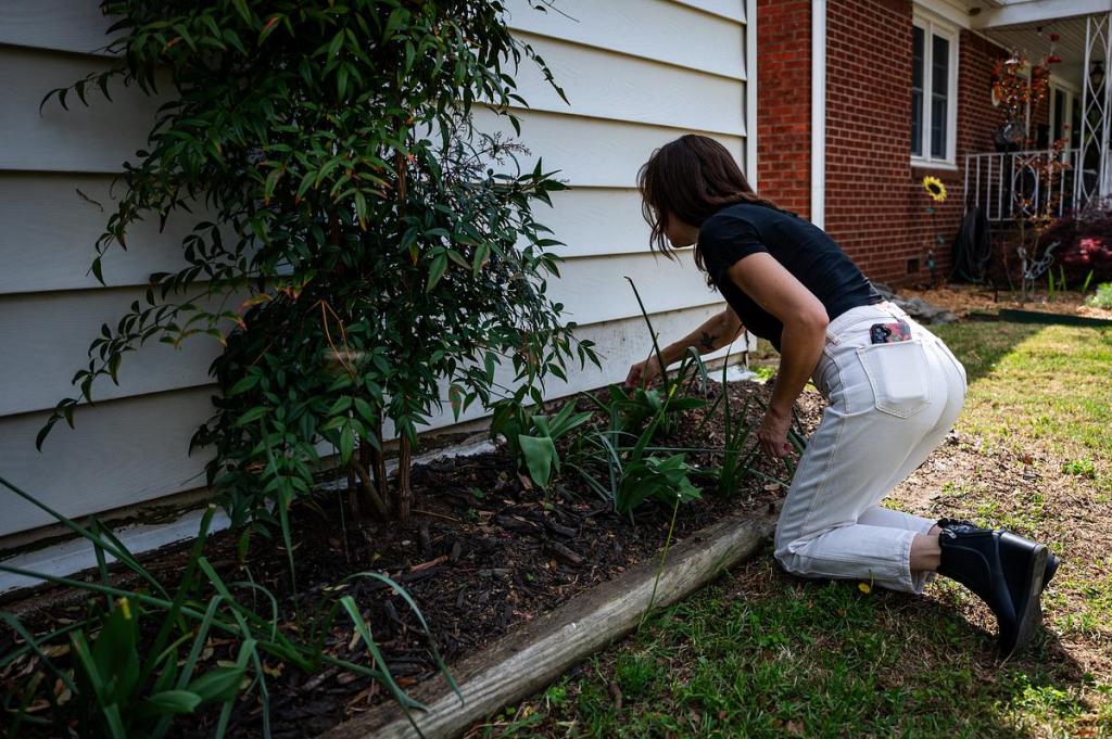 Lindsay tends to her garden in her front yard on Thursday, April 9, 2026. Lindsay is currently recovering from kratom addiction and her garden has been instrumental in her recovery process.