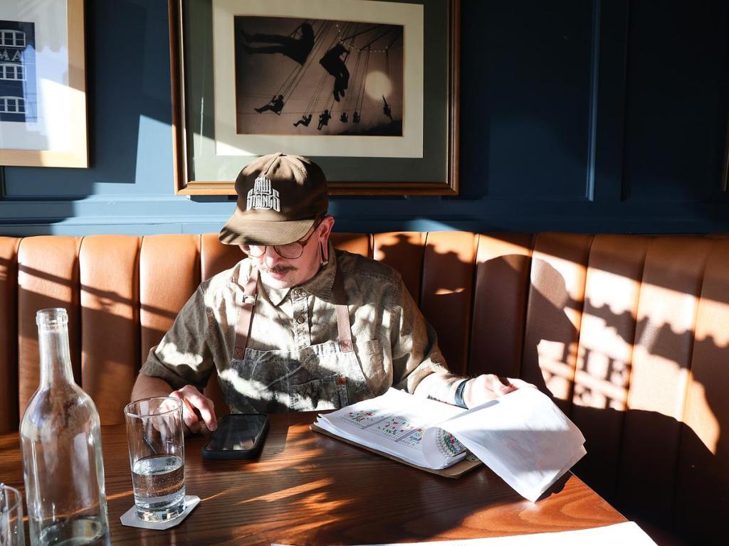 Tavern Executive Chef Austin Plumlee works on a food order inside the restaurant's dining room on Jan. 21, 2026. 