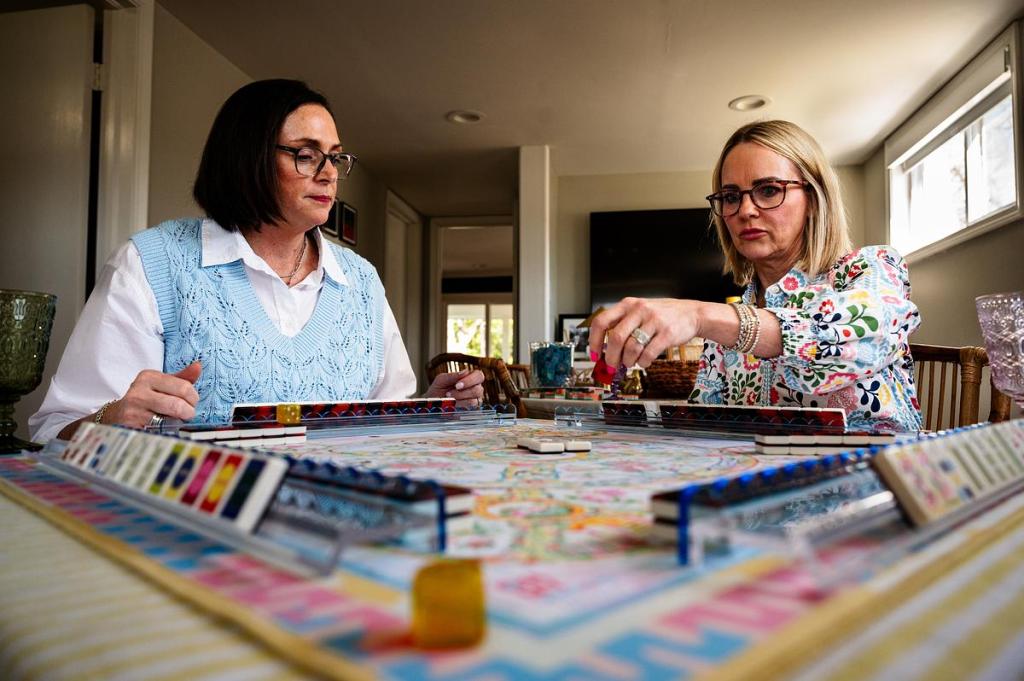 Nicolle Warren, left, and Candace Nees play mahjong March 26, 2026. The pair play and teach American mahjong as part of Mahj918, the organization they cofounded last year.  