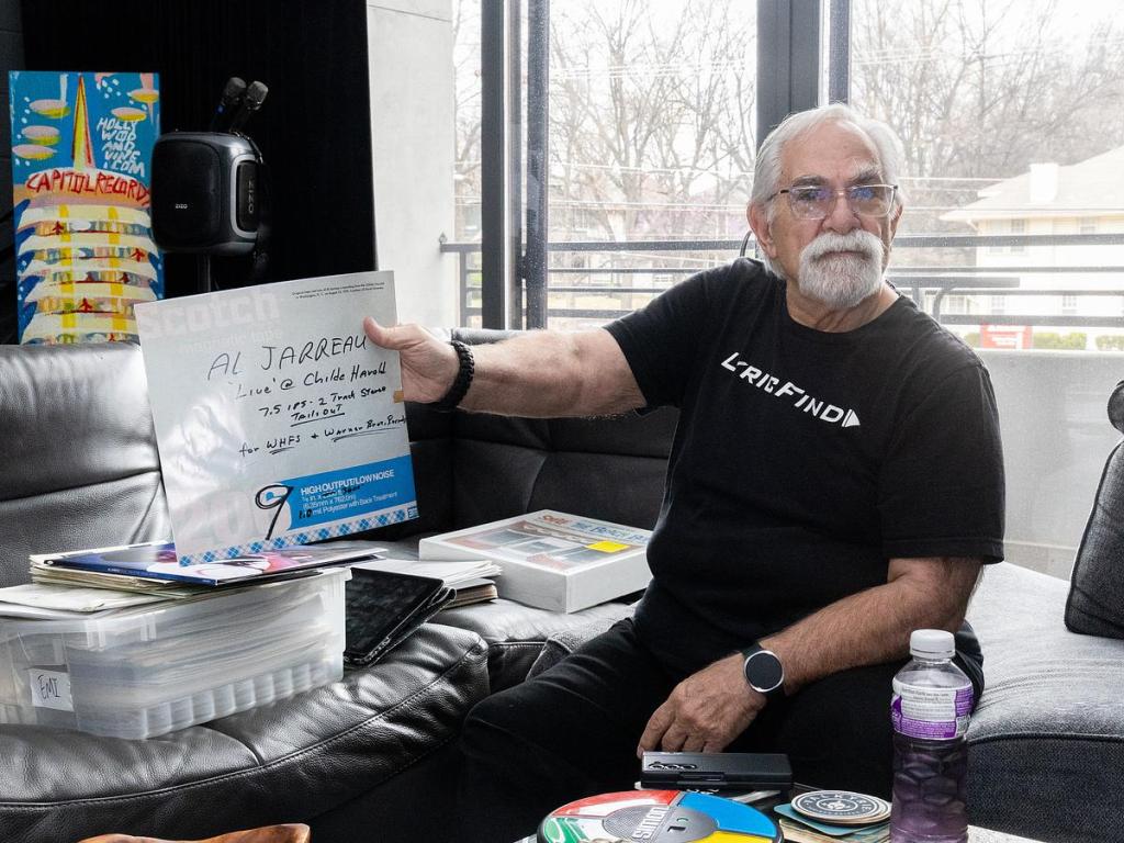 Ted Cohen shows off a vinyl copy of "Al Jarreau 'Live' at Childe Harold." He was interviewed for an essay that was included with the record. 