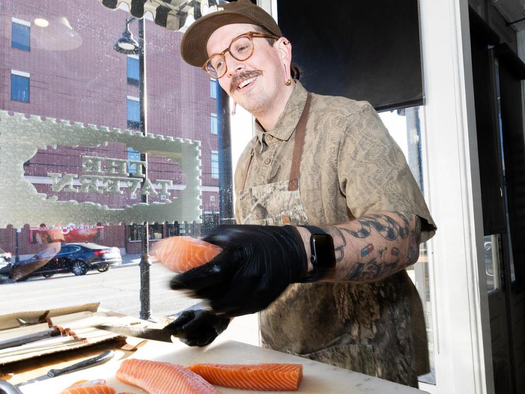 Tavern Executive Chef Austin Plumlee cuts salmon into filets for a dinner service on Jan. 21, 2026. The same table is used for Chef's Table experiences on Friday and Saturday nights. 