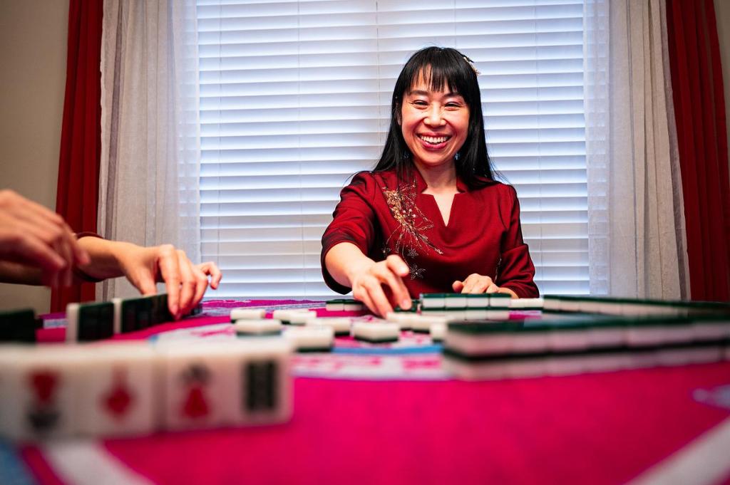 Alpha Zhang plays traditional Chinese mahjong April 1, 2026. Zhang is a professor of Chinese language and literature at The University of Tulsa.