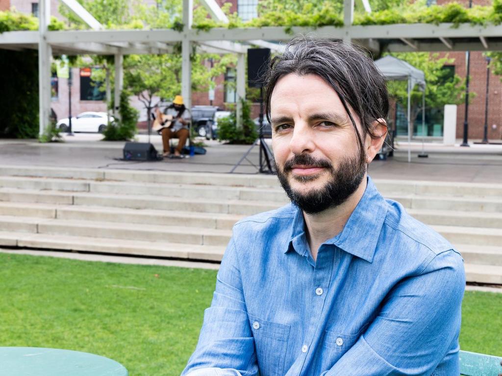 Scott Bell, creative production manager for Guthrie Green, hangs out on the lawn during Food Truck Wednesday on April 15, 2026. 