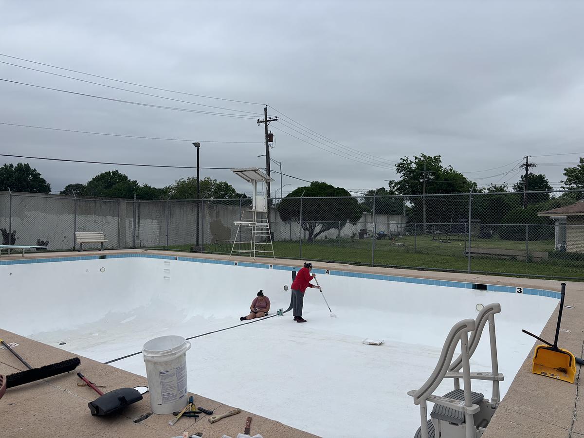 Candy Matheny, manager of Valley Glen Pool, paints the bottom of the pool April 28, 2026, in east Tulsa. Matheny is part of the Columbus Neighborhood Association, which owns the pool.