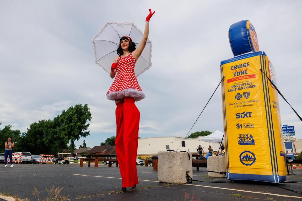 A stilt performer stands along E. 11th St. while entertaining spectators at the Route 66 Capital Cruise, a Guinness World Record attempt for the largest classic car parade ever on Saturday, May 30, 2026 in Tulsa, Oklahoma.