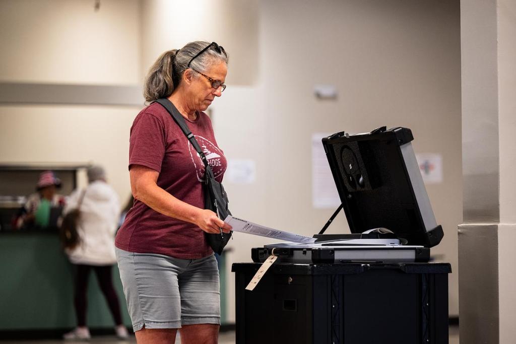 A voter submits their ballot during the early voting period at the Tulsa County Election Board precinct Wednesday, April 2, 2026.