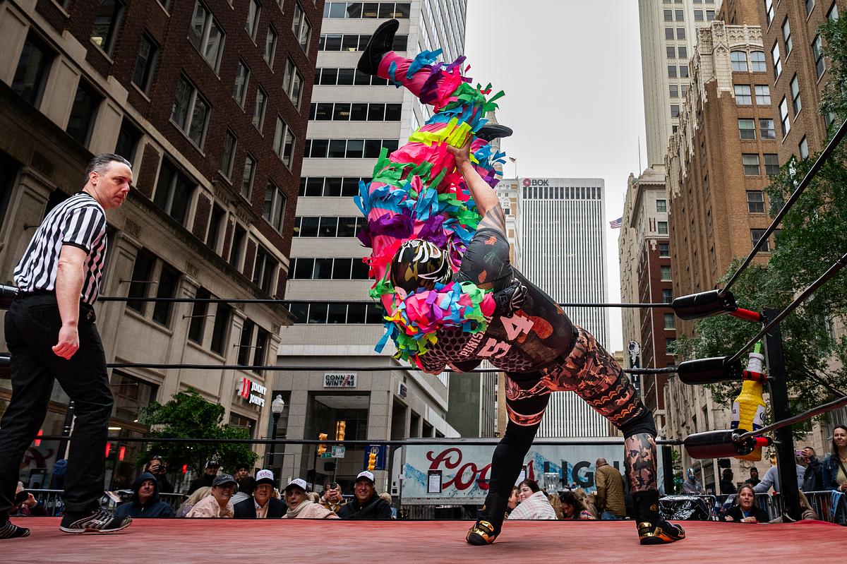 Super Gigante Piñata, left, gets thrown by Corporal Punishment during the Cinco De Mayo Luchador Wrestling event outside Elote Cafe & Catering on Tuesday, May 5, 2026.