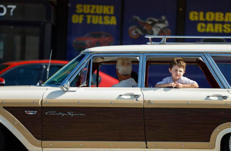 A child looks out the window of a classic station wagon during the Route 66 Capital Cruise May 30, 2026