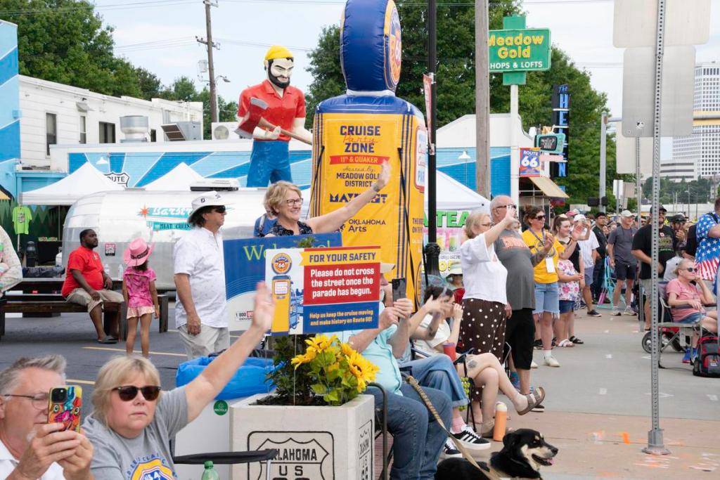 Spectators wave at participants in the Route 66 Capital Cruise on May 30, 2026. The cruise was an effort to break a world record for largest classic car cruise.