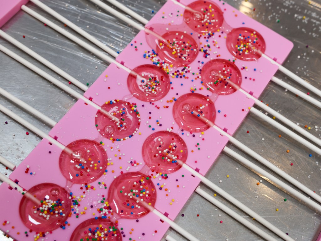 Lollipops are being made that will be given to diners at the end of their meals at Lollipops Woodfire & Grocery on May 20, 2026.