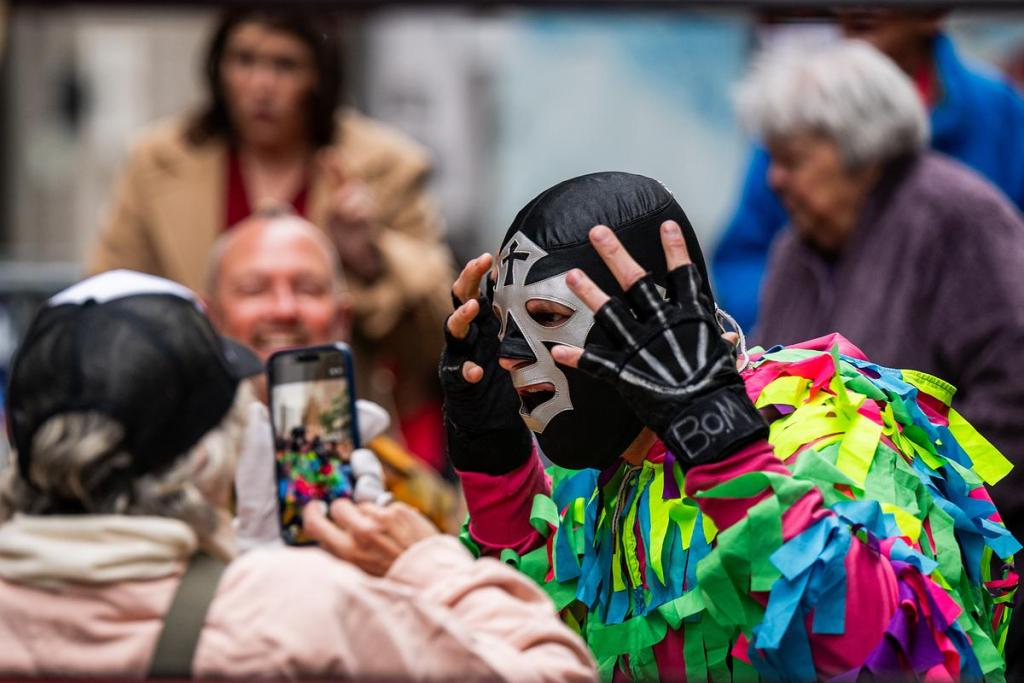 Super Gigante Pinata shares a moment with a fan during the Cinco De Mayo Luchador Wrestling event outside Elote Cafe & Catering on Tuesday, May 5, 2026.