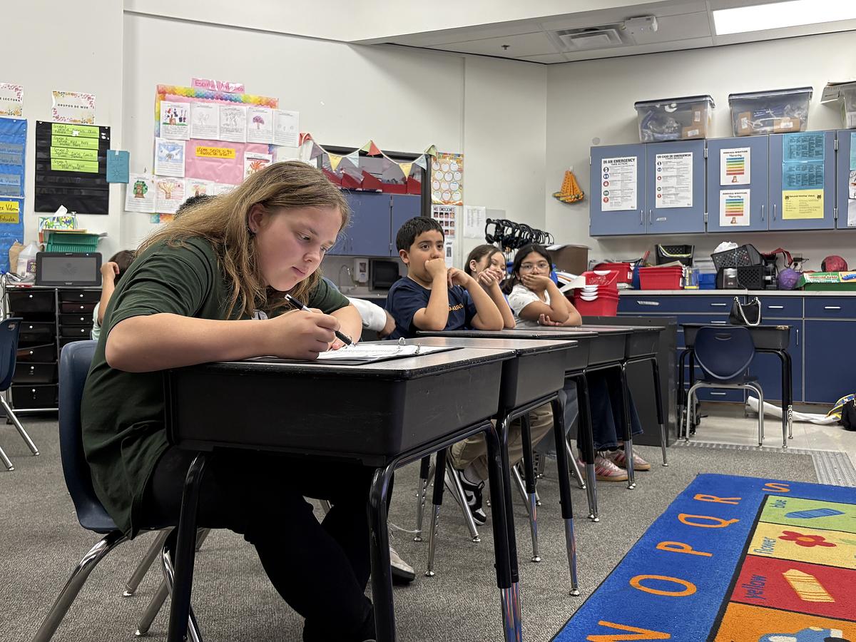 Fifth grader Maisy Archer, left, double checks the petition signatures she's collected about school meals at Kendall-Whittier Elementary April 23, 2026.