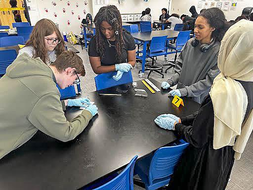 Grayson Mosher, left, works with fellow students in Cat Payton's forensic science class at Memorial High School.
