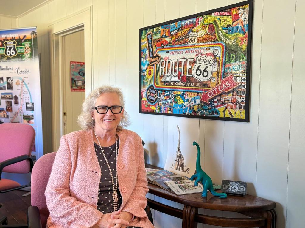 Teresa Flusche, executive director of the Tulsa Route 66 Main Street, sits for a portrait May 7, 2026, at their office in west Tulsa. The organization will add a 66-foot dinosaur sculpture to Howard Park, located at 2510 Southwest Blvd., later this year.