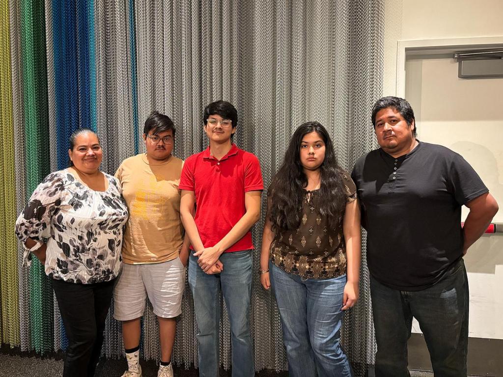 Dylan Ledesma, center, is surrounded by family at the Tomás Rivera awards ceremony on May 14 at Central Library. Ledesma is a senior at Will Rogers High School and received recognition from the commission. 
