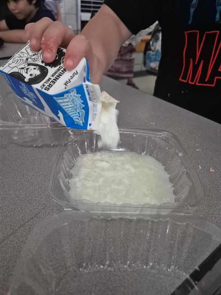 Tulsa Changemakers pour a milk carton before a club meeting April 14, 2026. They opened the milk on it's expiration date to find chunks and a sour smell.
