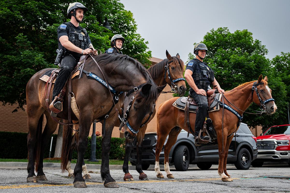 Tulsa Police officers from left: Cody West riding Wrecker, Annika Tollefson riding Rosie and Darin Howse riding Horsey stand on North Boston Avenue next to the Guthrie Green on Wednesday, May 20, 2026.