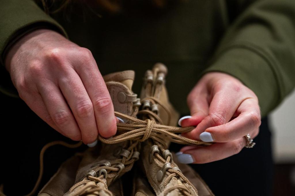 Shannon Lucas sets up combat boots for the annual Memorial Day display at the Broken Arrow Veterans Center Friday, May 22, 2026.