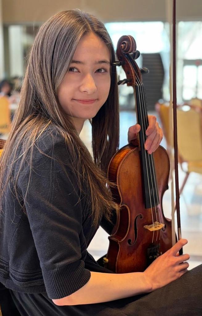 Madison Ingram poses with her violin. She graduates from Edison High School May 22, 2026. 