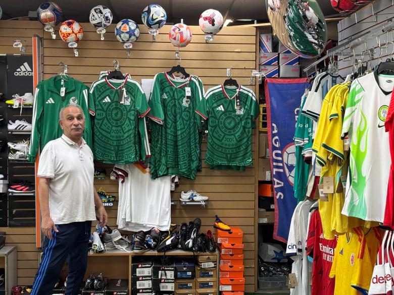 Ali Adibi, owner of SoccerUSA, stands near the remaining World Cup merch he has in his store on Sheridan Road. Adibi said they have sold out of the majority of Mexico and USA merch.