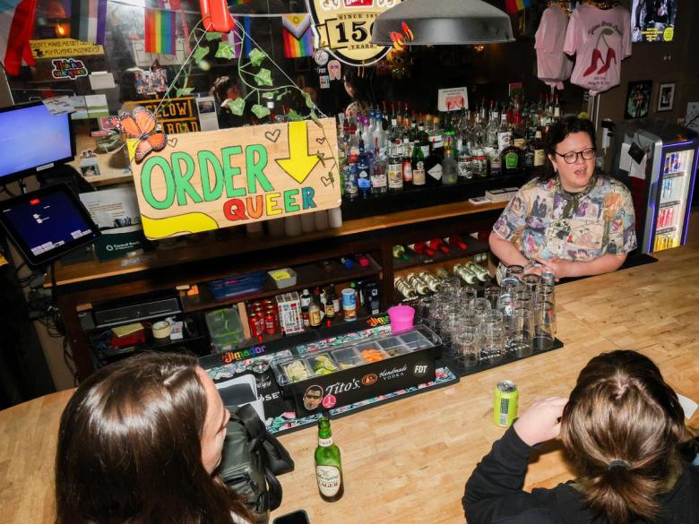 Bar patrons chat with Val Binkley, bar manager at Yellow Brick Road Pub, during a May 20, 2026, shift.