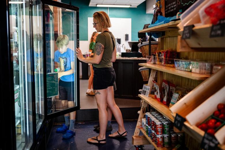 Leon, left and his mom Shannon Wheeler pick out breakfast burritos and juices at Chop Grocer on Thursday, June 25, 2026.