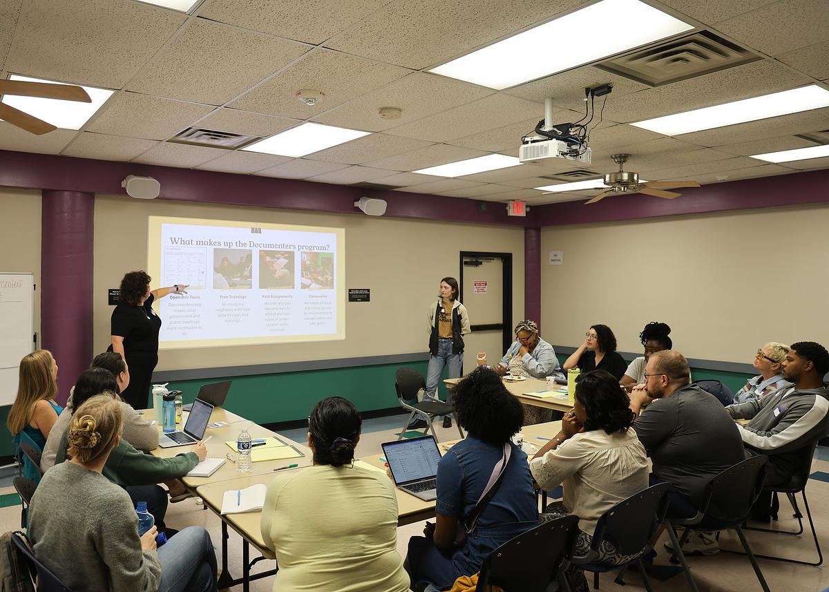 Documenters editor Sam Stockley, left, reviews the Documenters program at a June 14, 2025, meeting.