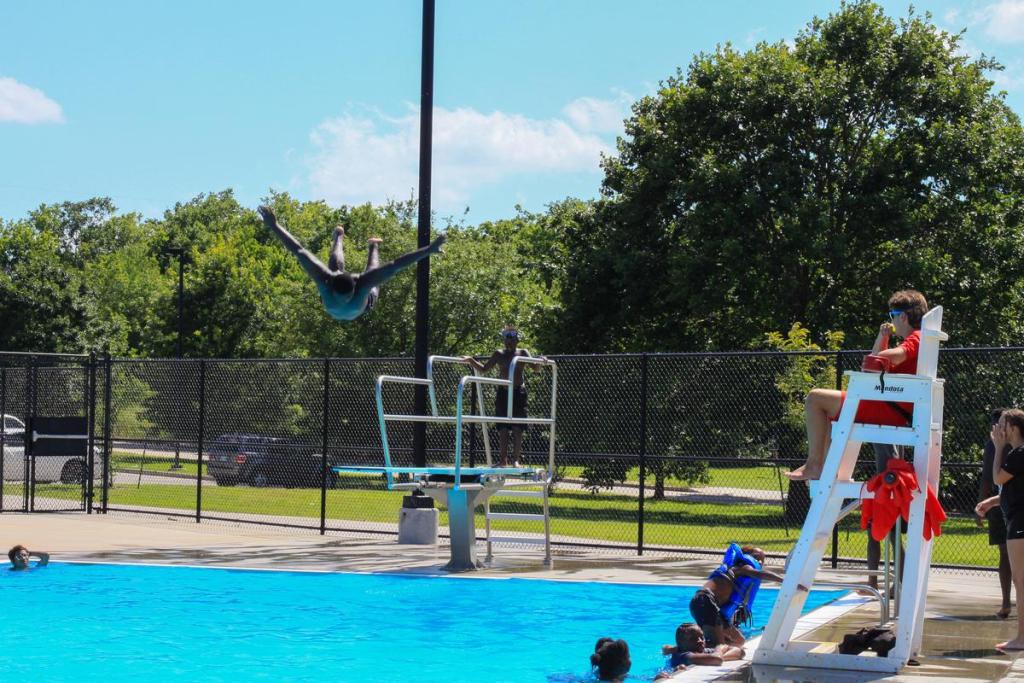 David Wild, 16, dives into the Lacy Park Municipal Pool as lifeguard Oliver Combs, 16, watches on Wednesday June 17, 2026. Combs is three weeks into his job at Lacy.