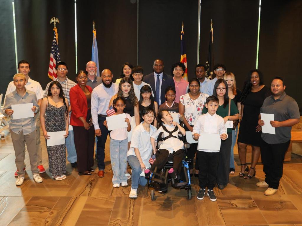  Twenty-two children from 12 countries took their oaths of allegiance at a citizenship ceremony held inside Gathering Place's Williams Lodge on June 11, 2026. 