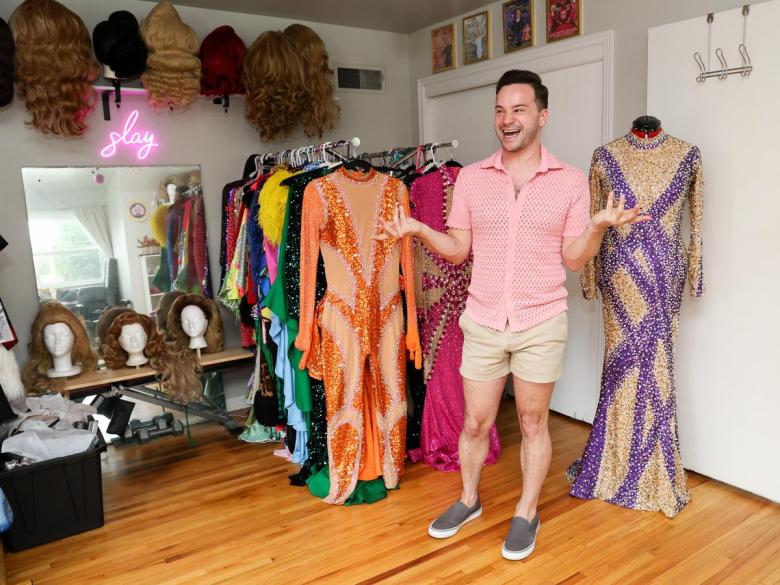 Travis Guillory in his midtown Tulsa home drag room surrounded by his collection of gowns and other items for his works as Tracy La Louisianne.