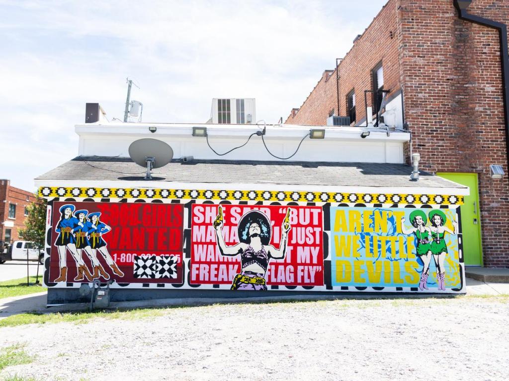 A mural created by Lauren Leigh Studios for Habit Mural Festival. The painting can be seen behind Lot 6, 1323 E. 6th St. 