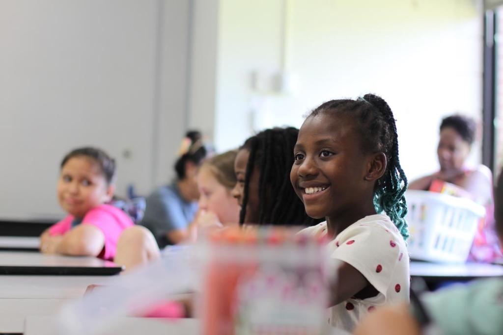 Tulsa Public Schools student Galena Anjanoh smiles during Tulsa SPCA's animal safety presentation at Kendall-Whittier Elementary on Tuesday, July 7, 2026. Dogs smile when they are happy or relaxed, students learned, just like kids do.