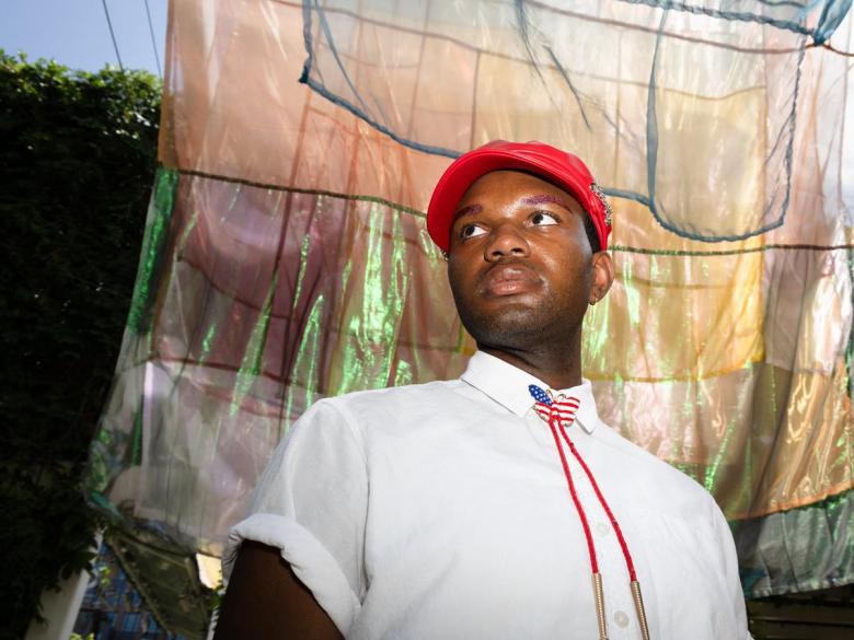R&B singer Donny Vinn stands under an art installation by Rachel Hayes on display at Guthrie Green on June 29, 2026. He's releasing a new EP, "Boy Americana," July 10.
