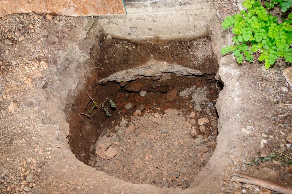 A hole at the Heights apartments is photographed on Tuesday, July 14, 2026. These holes are used to get under the ground to fix foundations due to soil erosion.