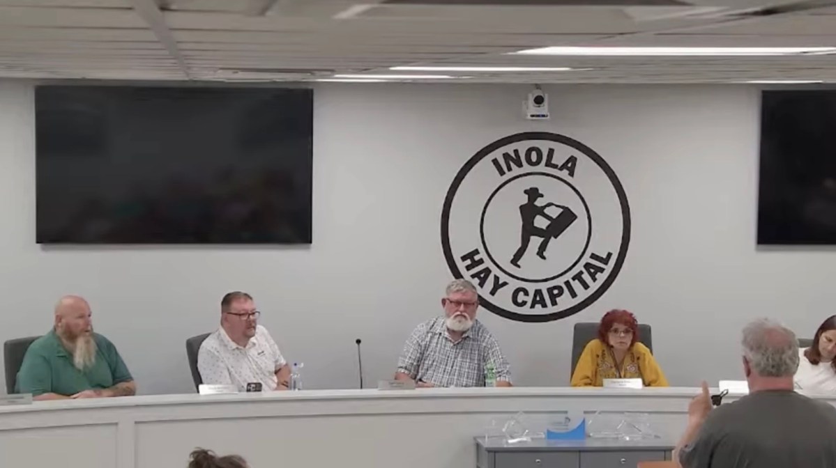 James Shaffer, bottom right, in gray shirt, submits his resignation to the Inola Board of Trustees on July 13, 2026.