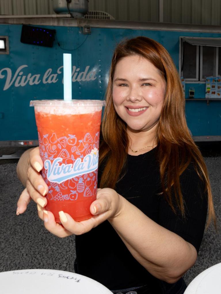 Alexis Rosales, owner of Viva La Vida, holds an agua fresca on July 13, 2026.