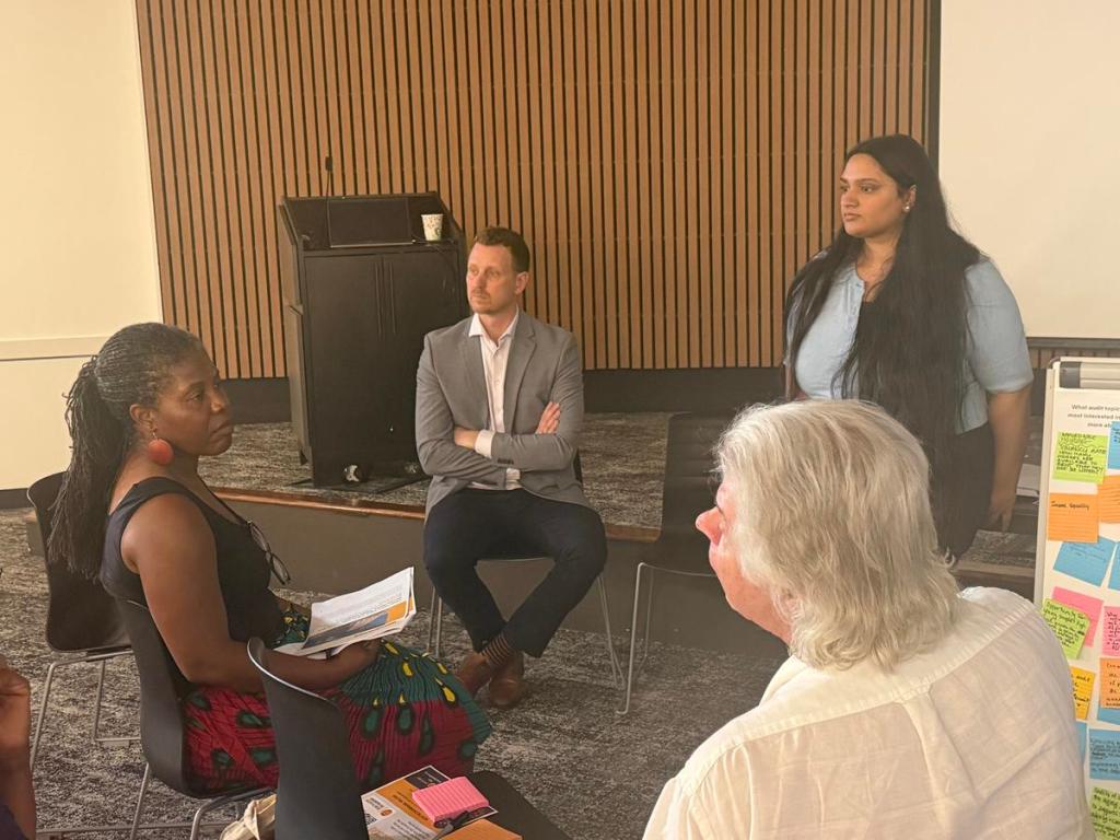 City Auditor Nathan Pickard, center, listens July 14, 2026, at the Martin Regional Library as the public asks questions about the findings on his recent citywide survey.
