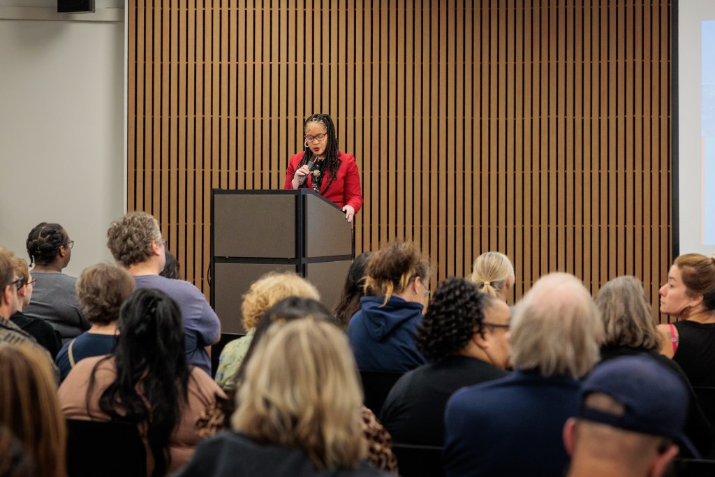 woman addresses crowd from podium