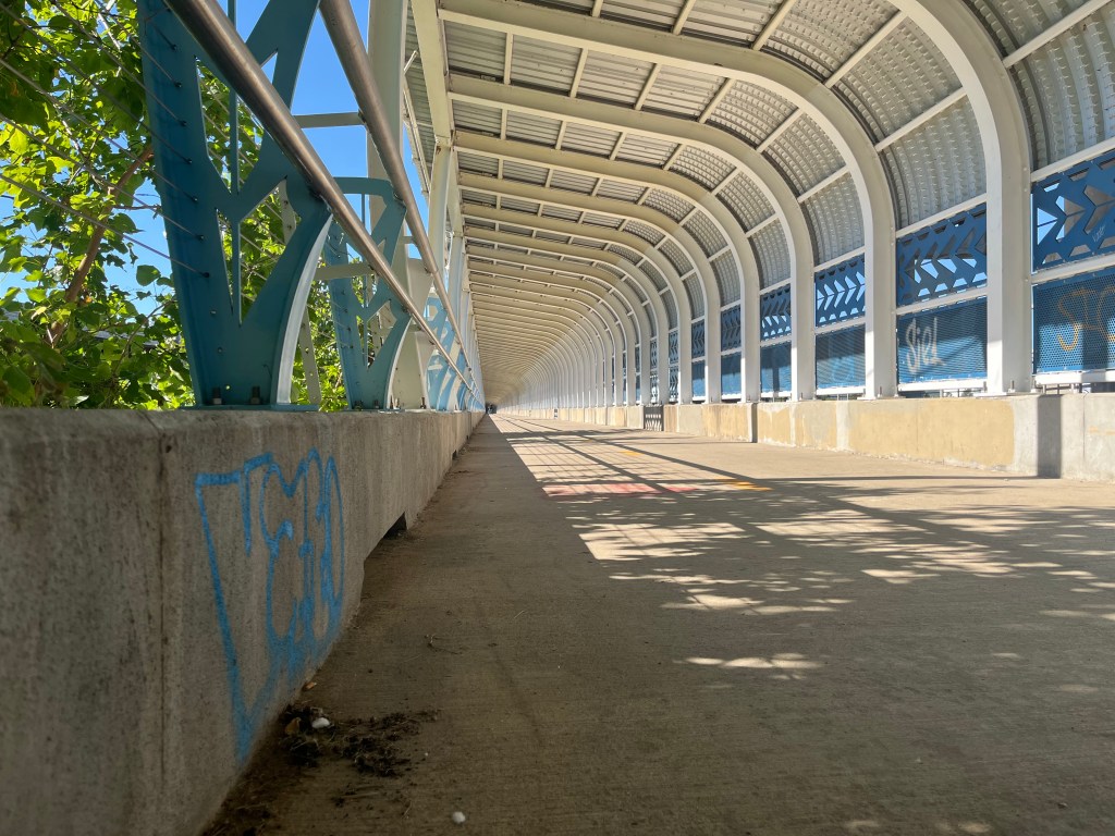 Graffiti, trash and broken lights: Who’s responsible for cleaning up this pedestrian bridge under Route 66?