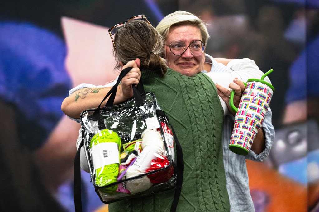 Gwendolyn Drumm, acting principal of Thoreau Demonstration Academy, hugs another attendee at the Tulsa Public Schools board meeting Monday, Oct. 19, 2026. The board voted 6-1 to approve a plan to close or consolidate 17 campuses, including Thoreau.