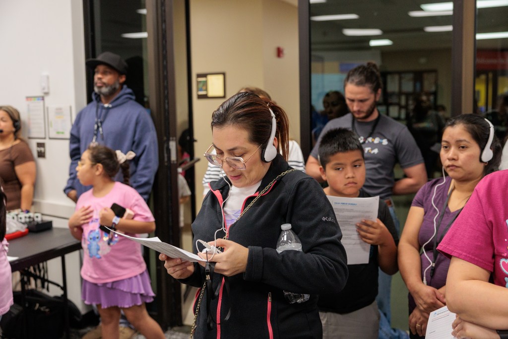 Families listen to Spanish interpretation during a Sept. 29, 2026, Tulsa Public Schools session about proposed school closures.
