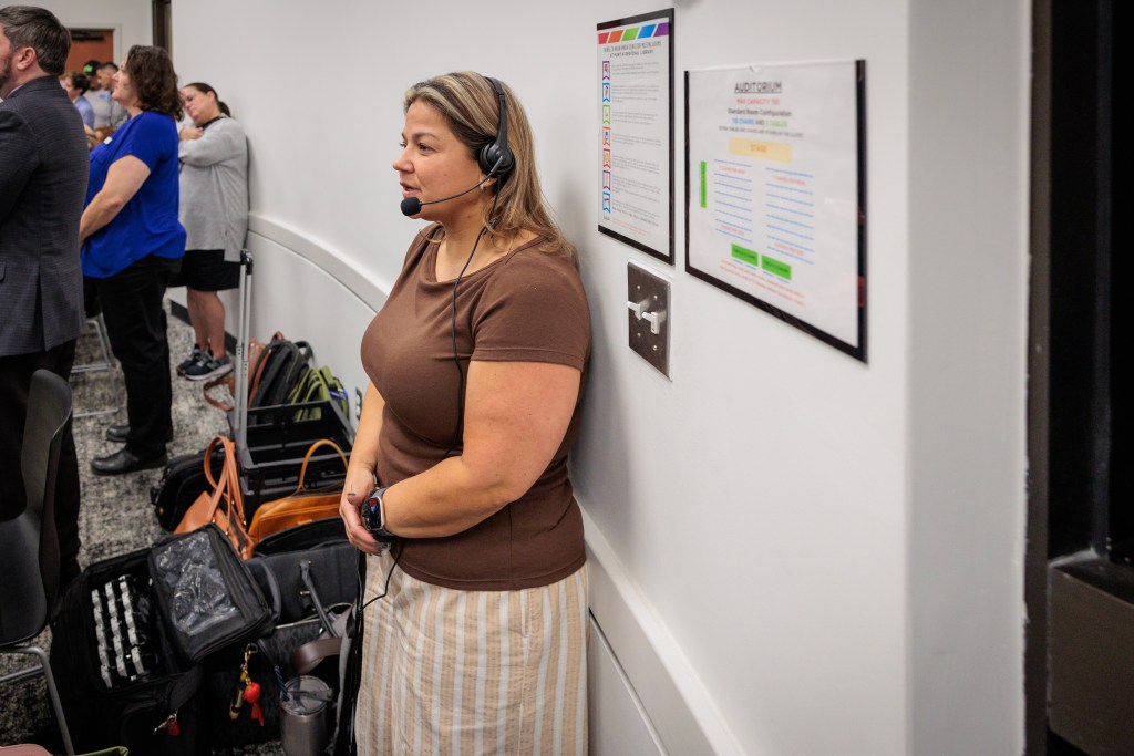A Spanish interpreter translates information to families during a Sept. 29, 2026, session at Martin Regional Library about proposed Tulsa Public Schools closures.