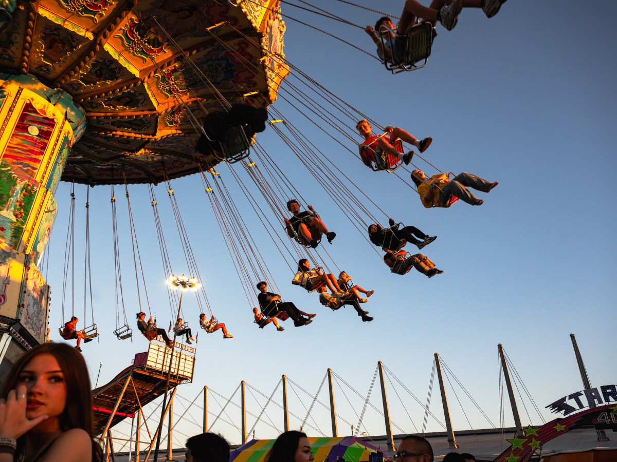 Inside the Tulsa State Fair, families take their pick of fried foods and coaster rides